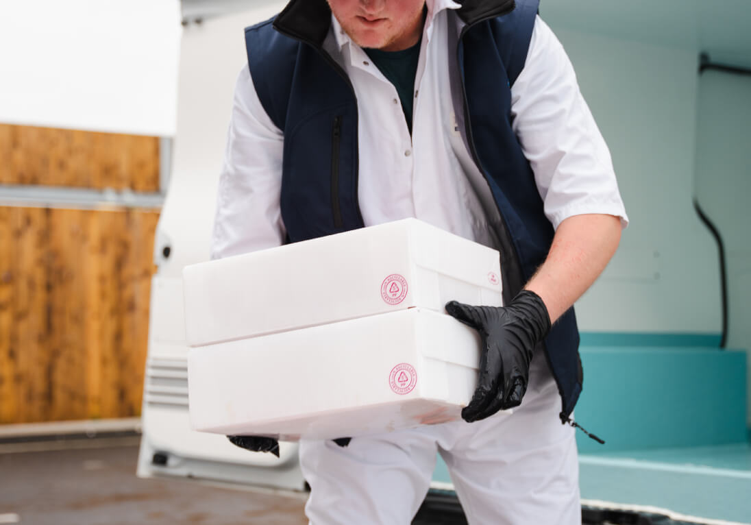 Man carrying Midland Fish boxes packaged in Tri Pack Packaging
