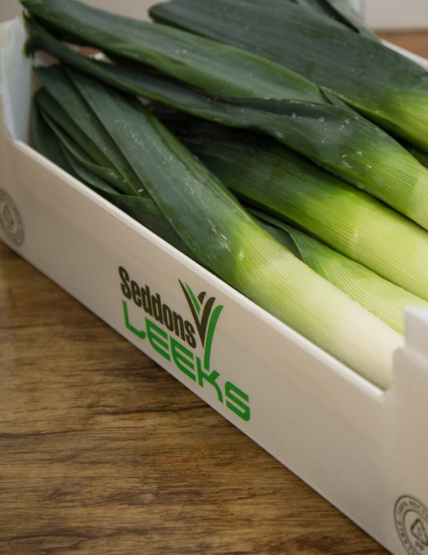 Leeks packaged in a Tri Pack box. Branded with "Seddons Leeks"